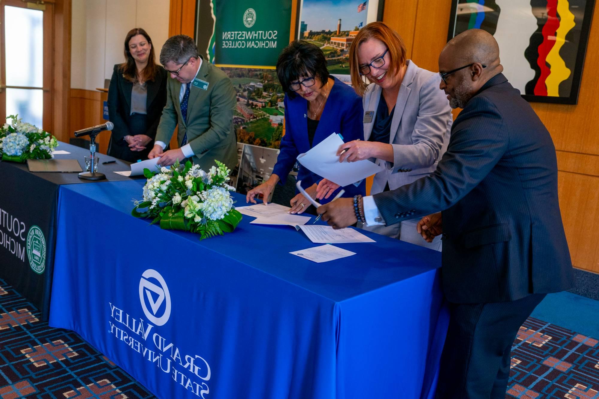 Southwestern Michigan College and GVSU representatives signing an agreement